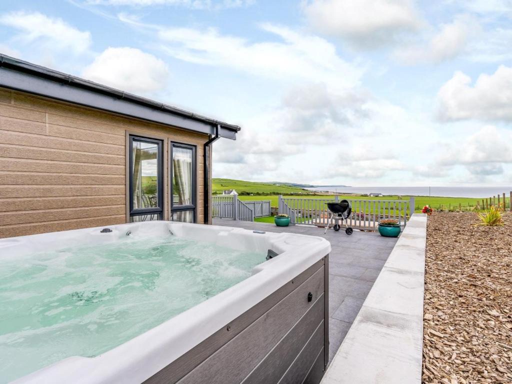 a hot tub on the patio of a house at 2 Bed in Newton Stewart oc-79129 in Gillespie