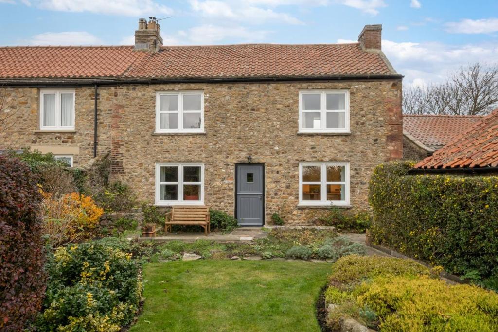 a brick house with a bench in the yard at 3 Bed in Catterick oc-ds934 in Catterick Bridge