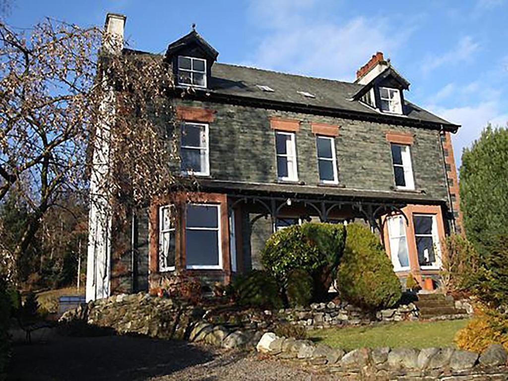 an old brick house with a hedge in front of it at 6 Bed in Keswick oc-sz044 in Braithwaite