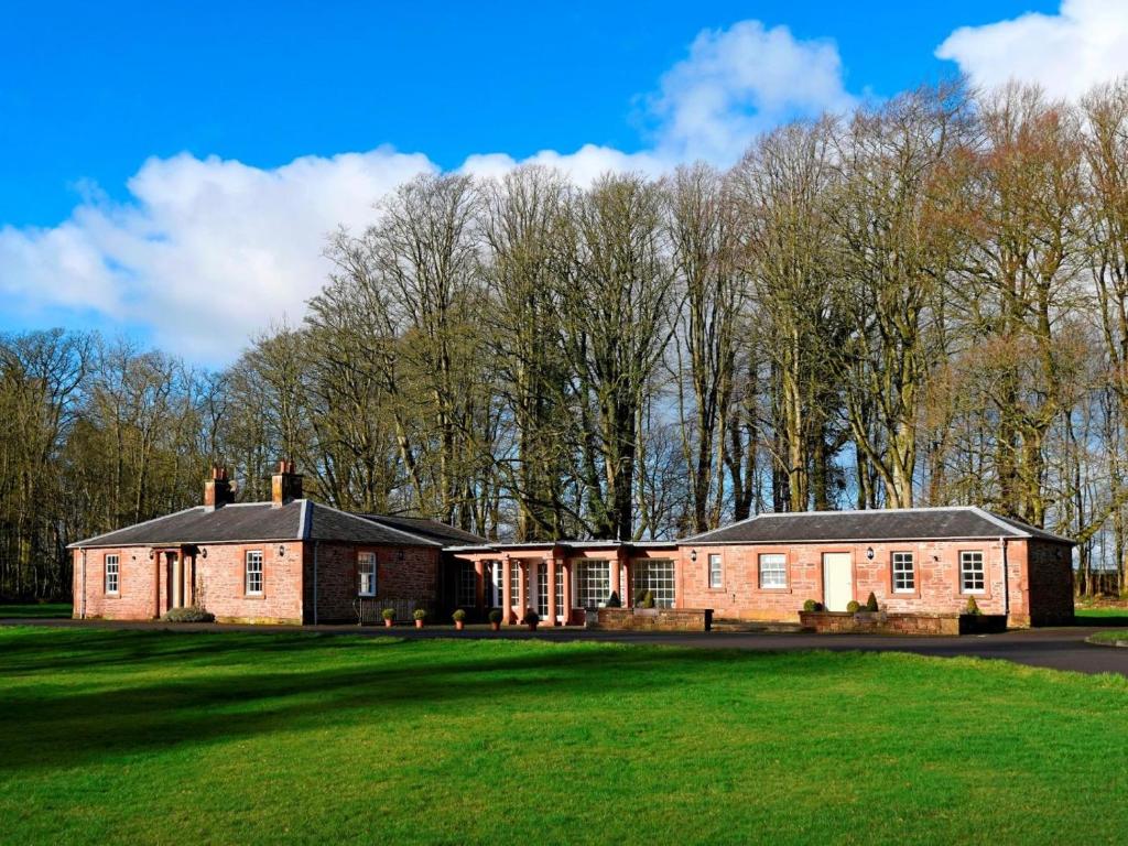 a large brick house on a green field at 3 Bed in Annan oc-75355 in Annan
