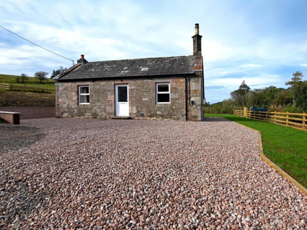 a small stone house on a gravel road at 1 Bed in Lockerbie oc-86068 in Lockerbie