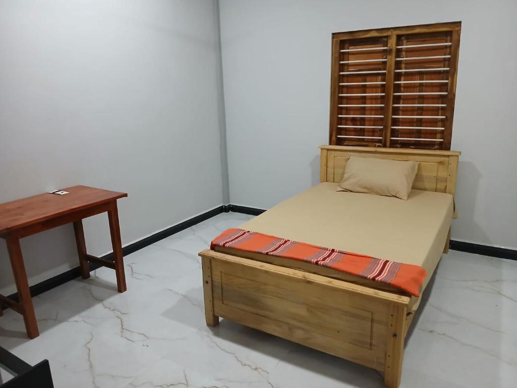 a bed and a table in a room at AR villa in Jaffna