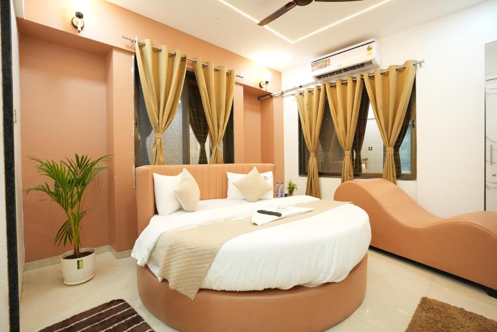 a bedroom with a large bed in a room at Elysia By THL-Near Westend Mall Aundh in Pune