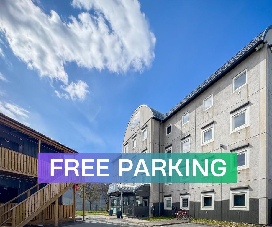 a sign that reads free parking in front of a building at First Hotel Jönköping North in Jönköping