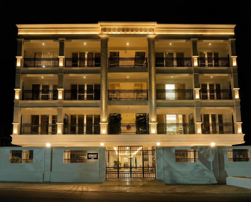 a large white building with lights on it at night at Arunaragha in Mysore