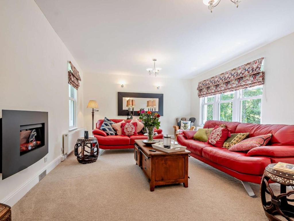 a living room with red couches and a fireplace at 3 Bed in Langholm oc-95053 in Langholm