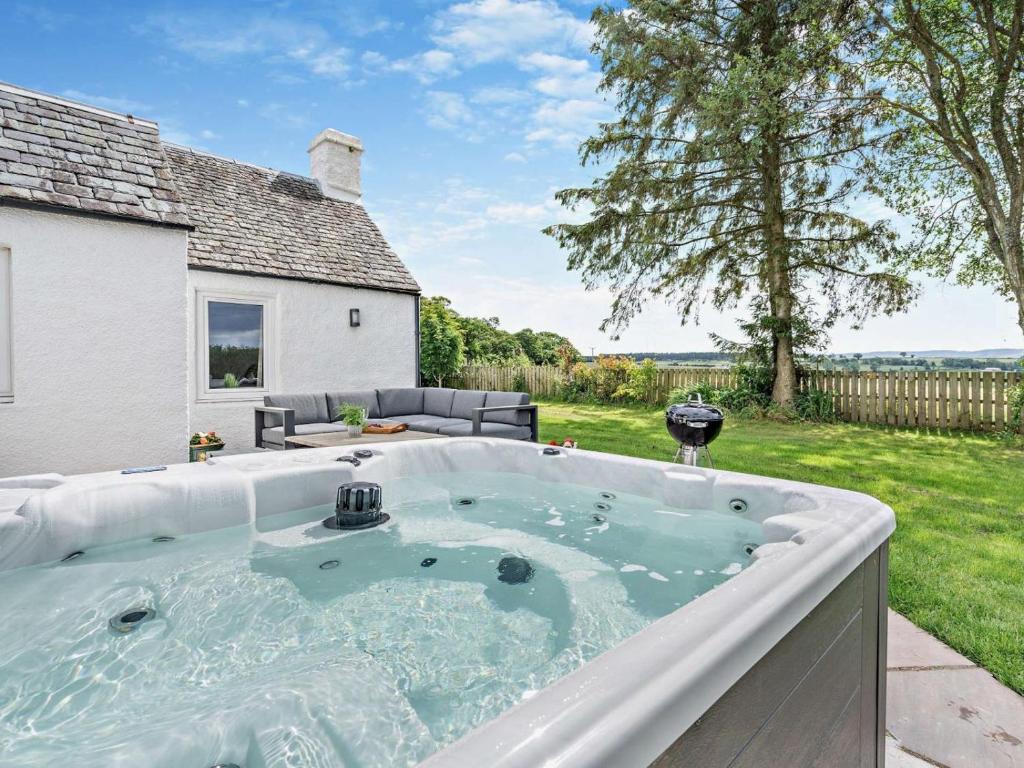 a hot tub in the backyard of a house at 3 Bed in Crieff oc-92683 in Madderty