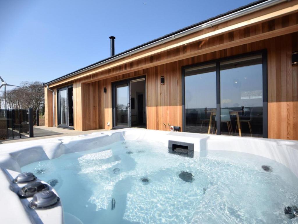 a jacuzzi tub in front of a house at 2 Bed in Anstruther oc-72436 in Anstruther