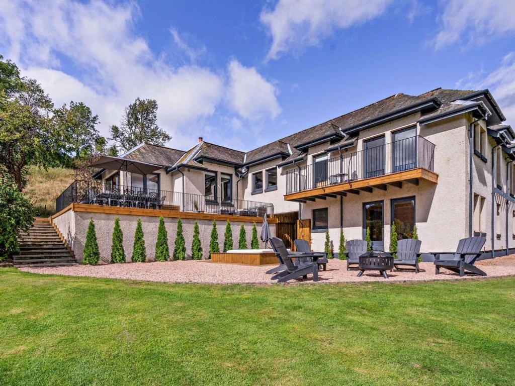 a large house with two benches in a yard at 6 Bed in Perth oc-96289 in Stanley