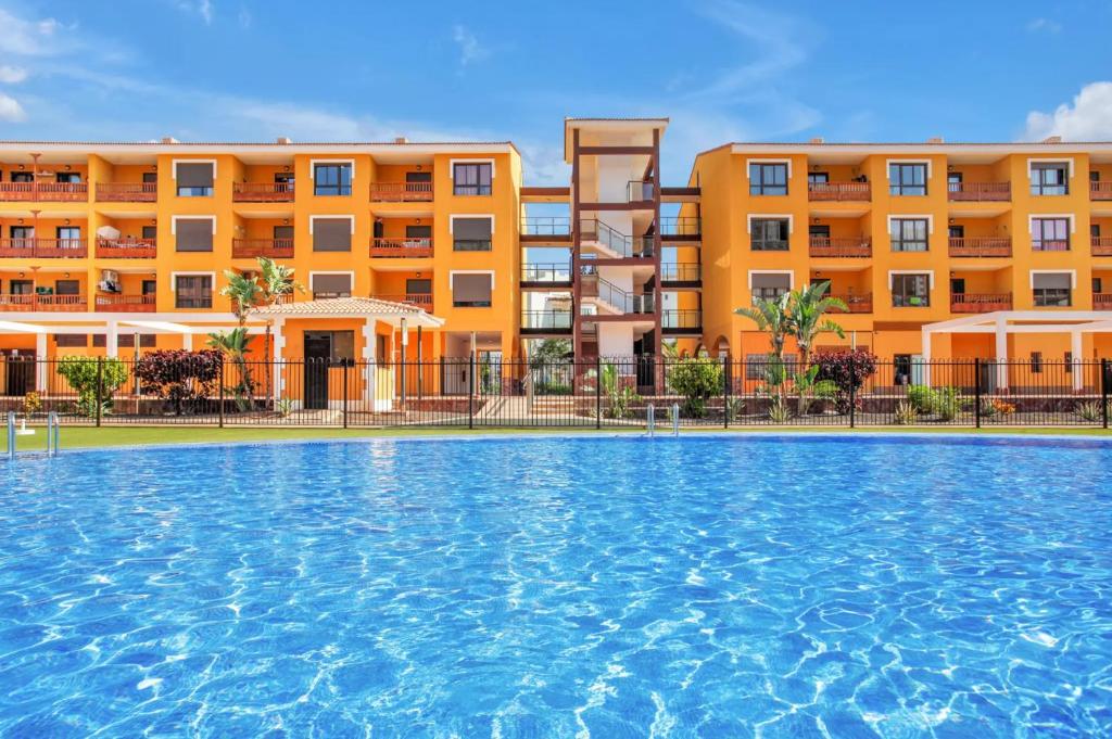 a large swimming pool in front of a building at Ojos del Océano in Palm-Mar