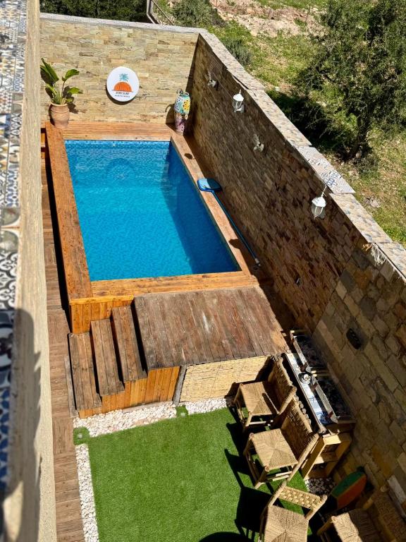 an overhead view of a swimming pool with a frisbee at Zeri Surf Taghazout Hiltop in Taghazout