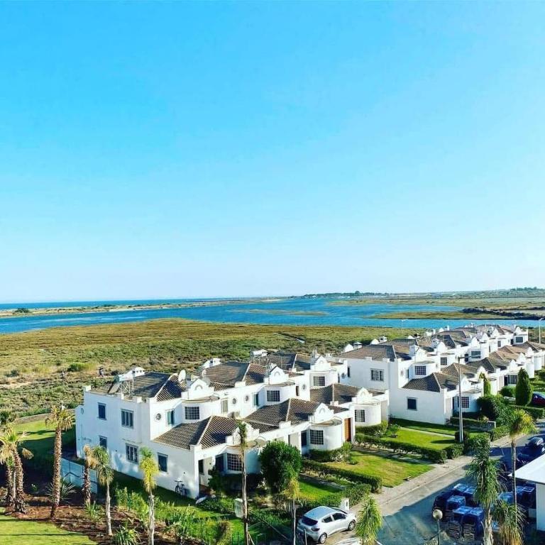 an aerial view of a row of houses near the ocean at Cabana da Ria in Cabanas de Tavira