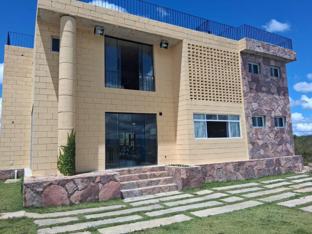 a house with a stone staircase in front of it at Casa Concept in Mucugê