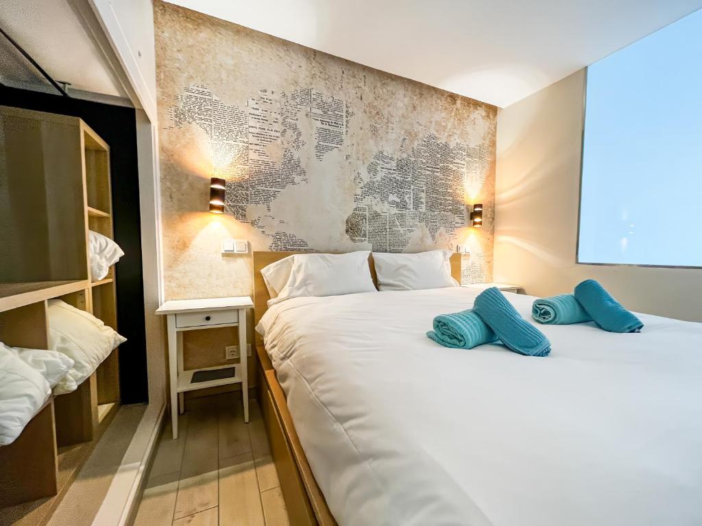 a hotel room with two beds with blue pillows on them at Casa Arno - Lovely Renovated Apartment In Playa De Mogan in Puerto de Mogán