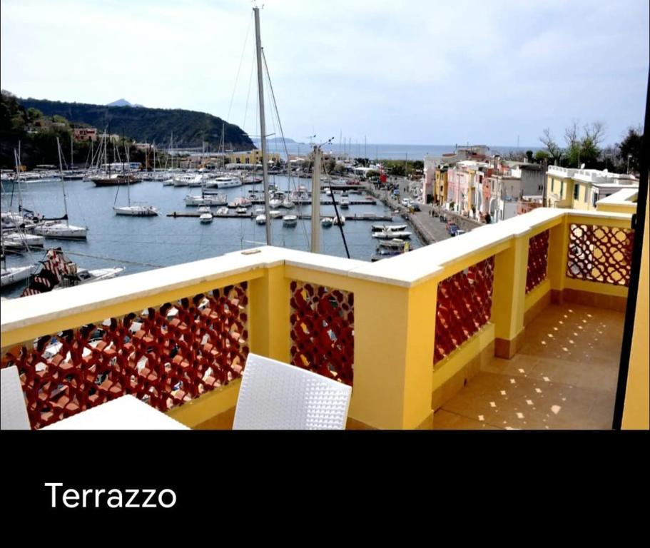 a balcony with a view of a marina with boats at Grande Procida in Procida