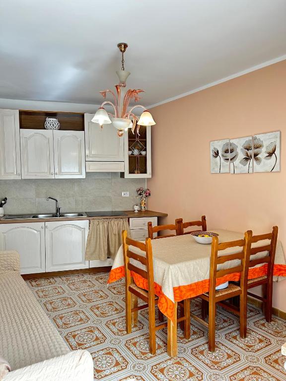 a kitchen and dining room with a table and chairs at La Casa del Sole in Corleone