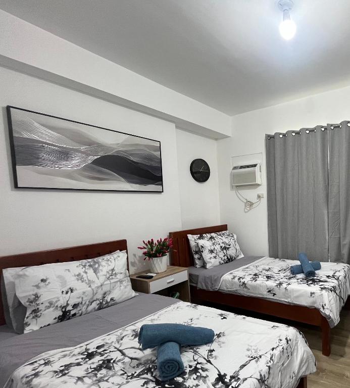 a small room with two beds and a window at Hailey's Place Unit 3 in Bacolod