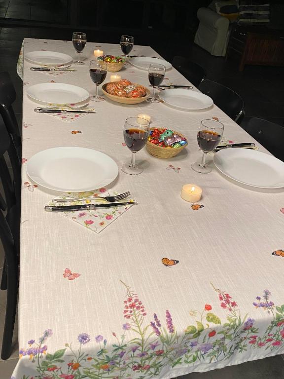a table with plates of food and glasses of wine at Bel air in Les Hauts-Geneveys