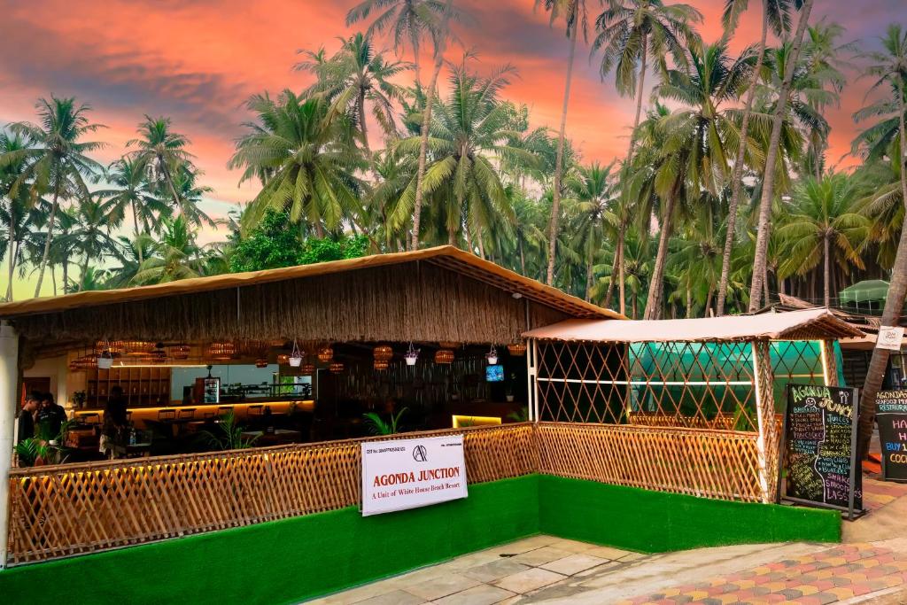 a restaurant with palm trees in the background at Agonda Junction in Agonda