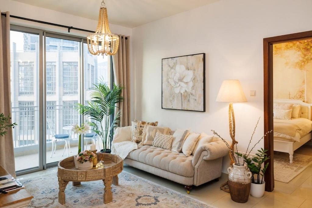 a living room with a couch and a table at Romantic hideaway with Burj view in Dubai