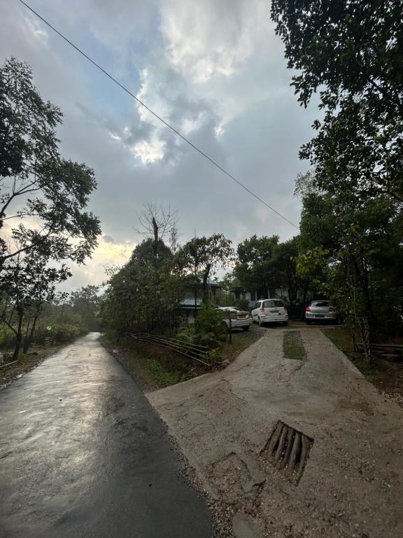 a flooded road with cars parked on the side at Verde Guest House in Shillong