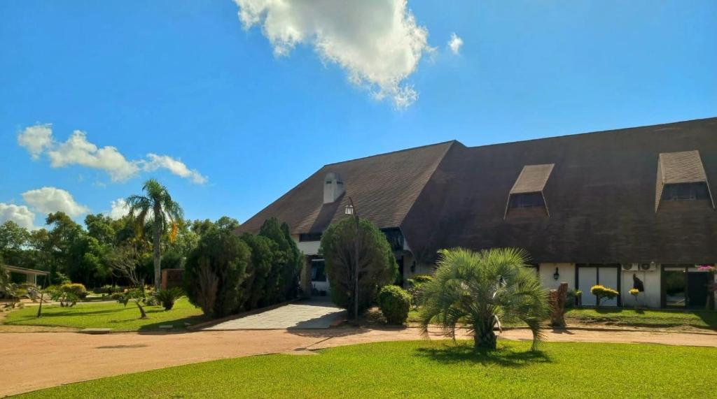 a large building with a black roof at Pontal Tapes Hotel in Tapes