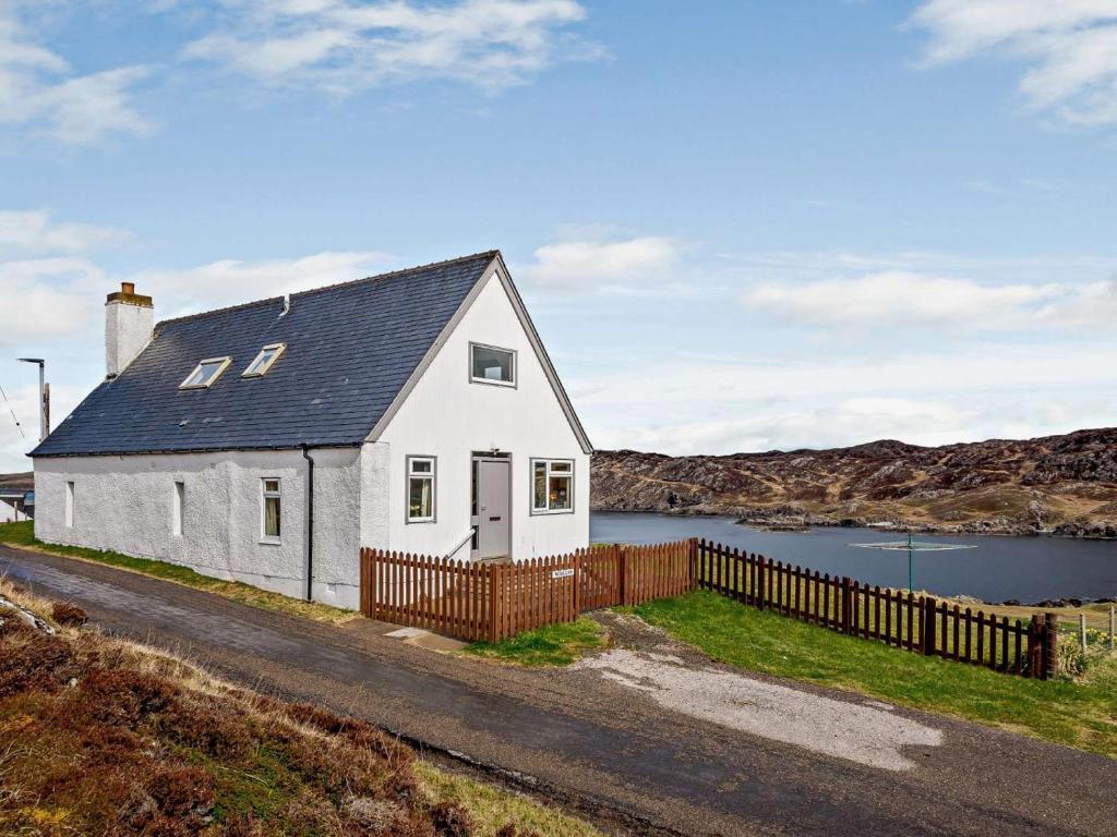 a white house on the side of a road at 4 Bed in Scourie oc-ca399 in Scourie