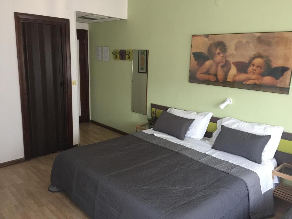 Postel nebo postele na pokoji v ubytování Hotel San Michele