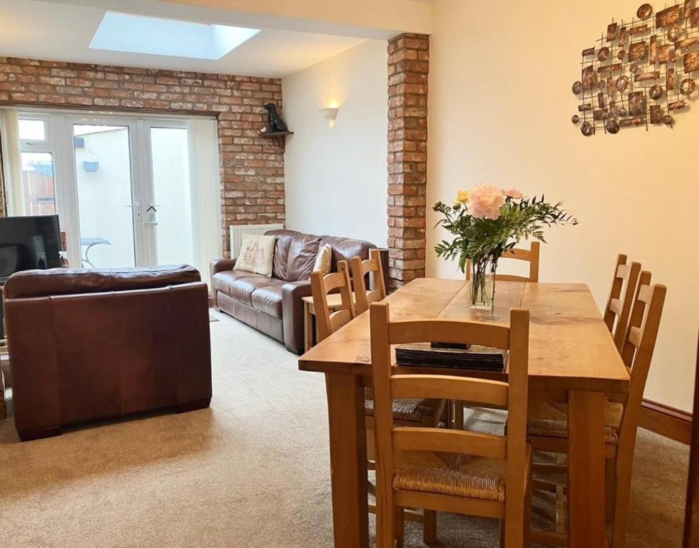 a living room with a table and a couch at Fiona's House in Filey