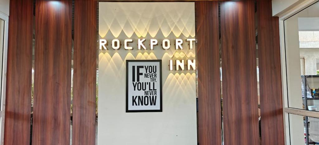 a door with a sign that reads rockport if you think you will see at Hotel Rock Port Inn in Rushikonda