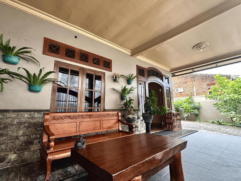 a room with a wooden bench in a house at Good Feeling Ijen Banyuwangi in Banyuwangi