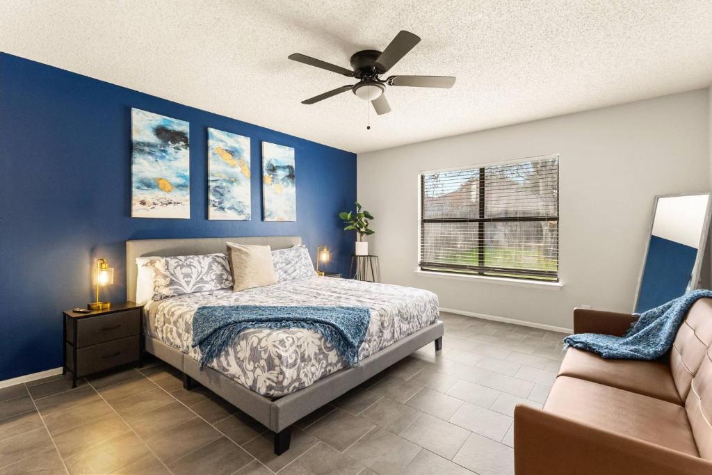 a bedroom with a bed and a ceiling fan at SeaCasa San Antonio in San Antonio