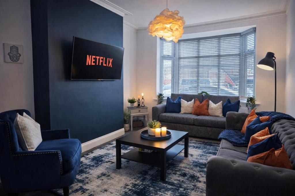 a living room with a couch and a table at York Boutique House- spacious & stylish with free parking in York