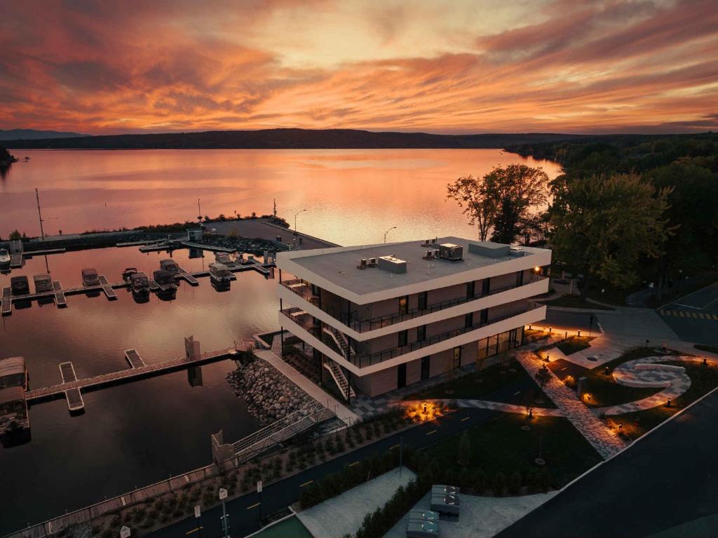 an aerial view of a building next to a marina at La Capitainerie du Lac-Mégantic in Lac-Mégantic