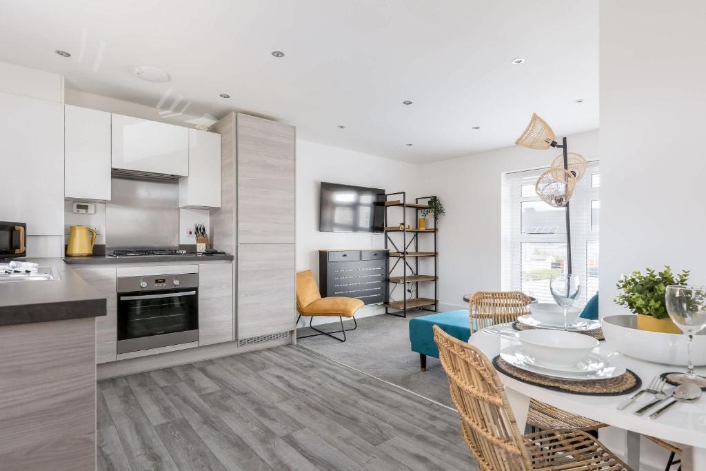a kitchen and living room with a table and chairs at Seas the Day - Moments from Hamworthy Beach and Park in Poole