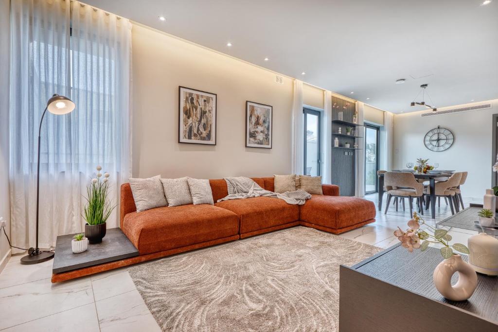 a living room with a couch and a table at 6BR luxury villa with Pool & Hot tub - 2Living rooms & 10Bathrooms in Tal-Għoqod