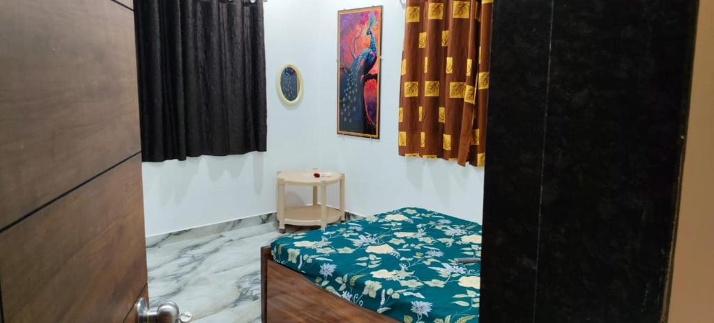 a room with a door with a bench and a table at Rmeshwar homestay in Malvan