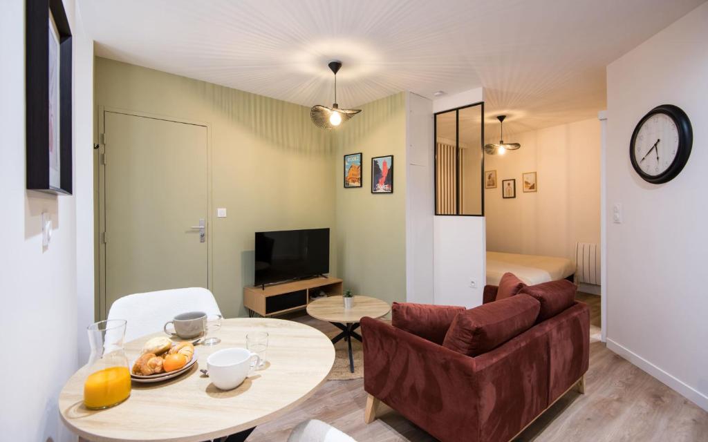 a living room with a couch and a table at Le Choeur in Rodez