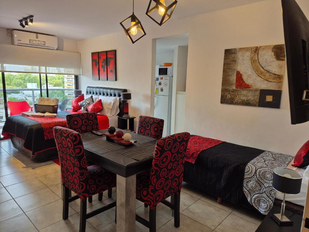a living room with a bed and a table and chairs at Confort Platense Centro Zona Catedral in La Plata