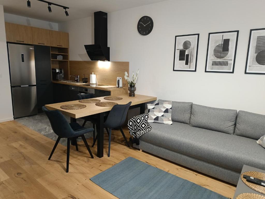 a living room with a couch and a table at APARTAMENT FLOW Walendów in Walendów