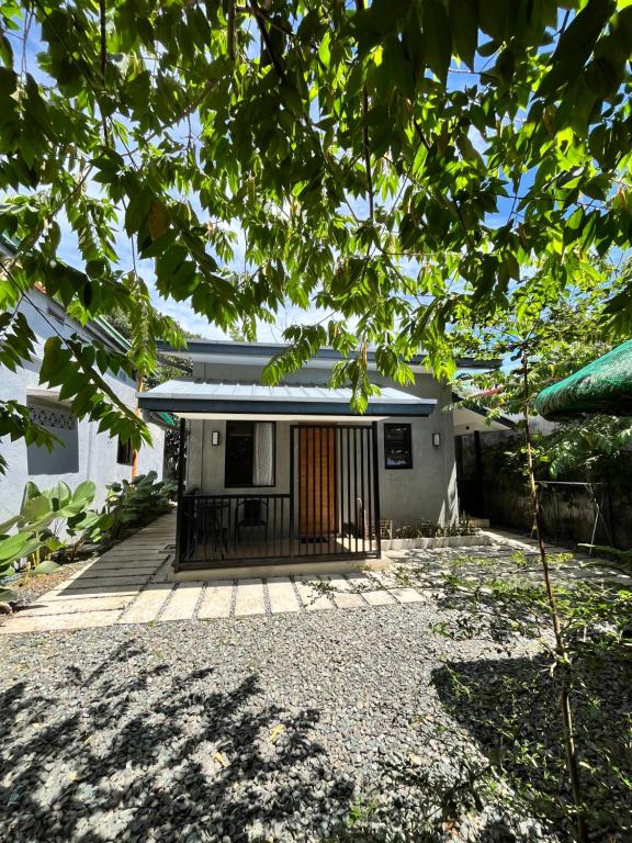 a small house with a gate in front of it at Pio Transient House in Tanay
