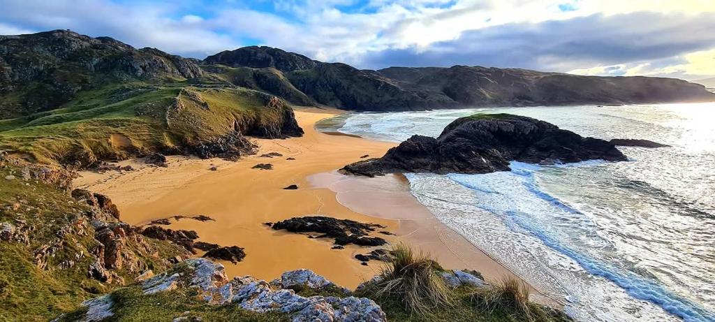 an aerial view of a beach with rocks and the ocean at Downings View in Ballynaworthra