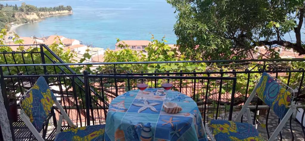 a table on a balcony with a view of the ocean at Panoramic Seaview Apartments - Koroni in Koroni