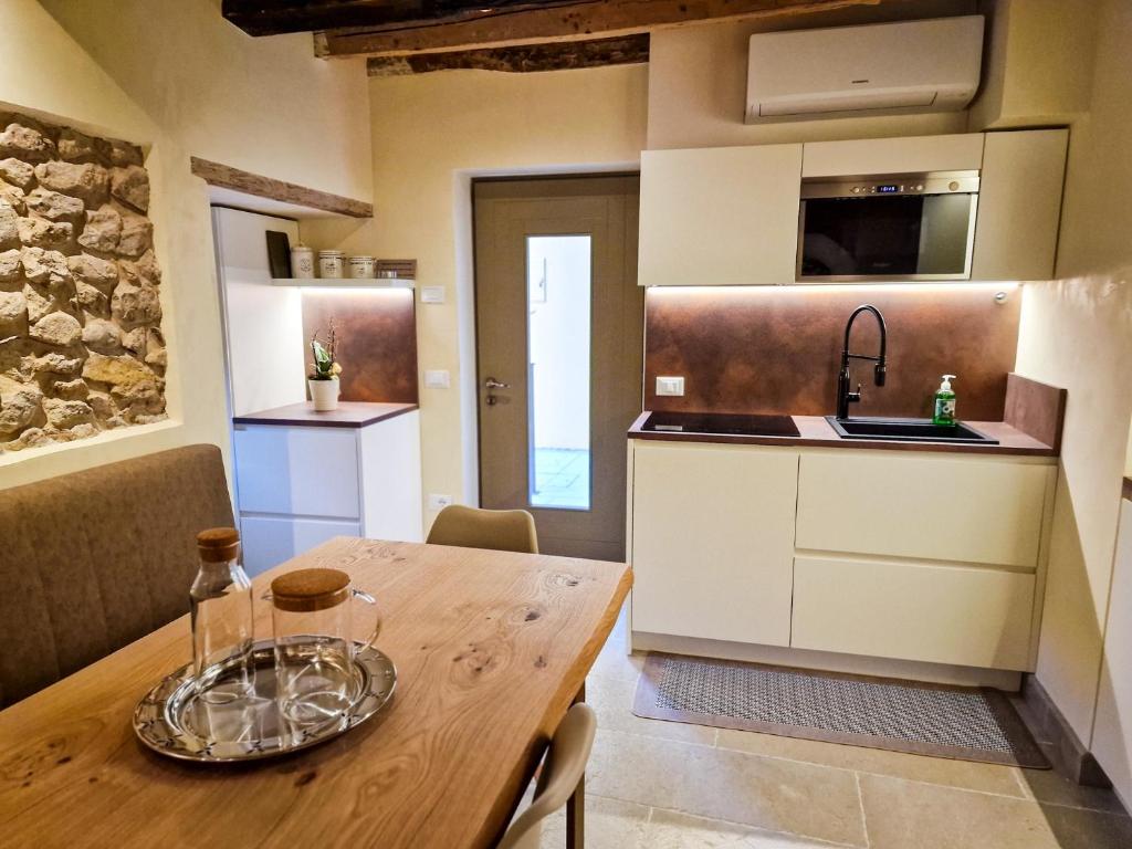 a kitchen and dining room with a wooden table at Sotto la Torre in Marostica
