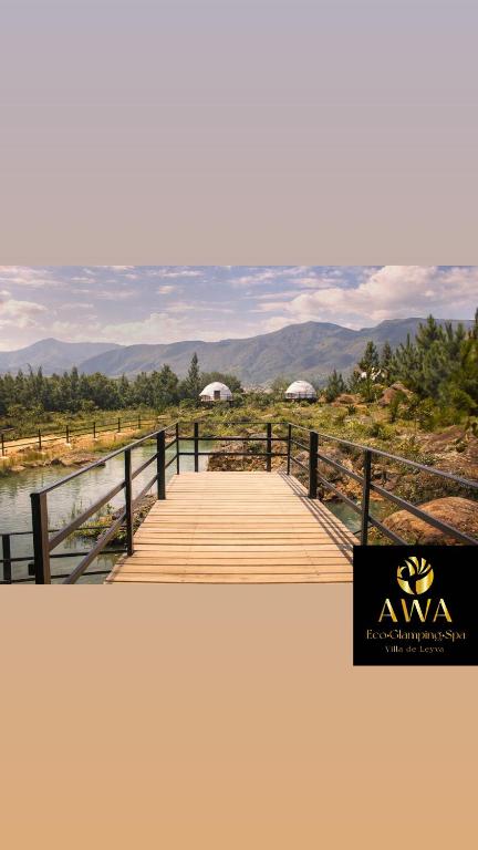 a wooden boardwalk with a view of the mountains at AWA ECO GlAMPING SPA in Villa de Leyva