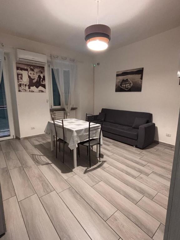 a living room with a table and a couch at Carlotta 5 in Biella