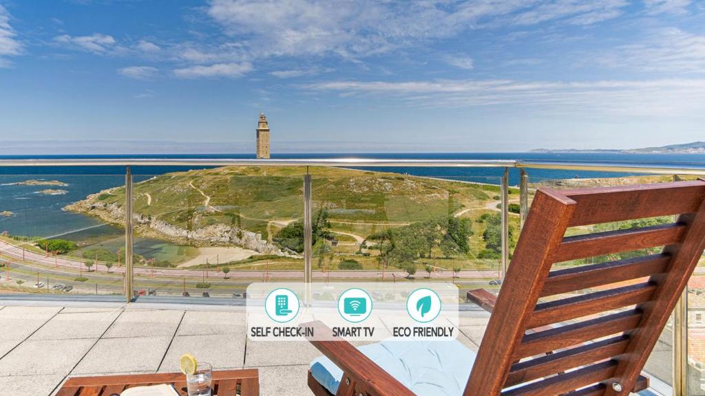 a view of a lighthouse and the ocean from a balcony at Blue Ocean Penthouse in A Coruña