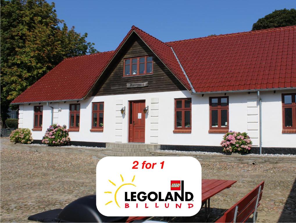 a white house with a sign in front of it at STAY Billund in Vandel