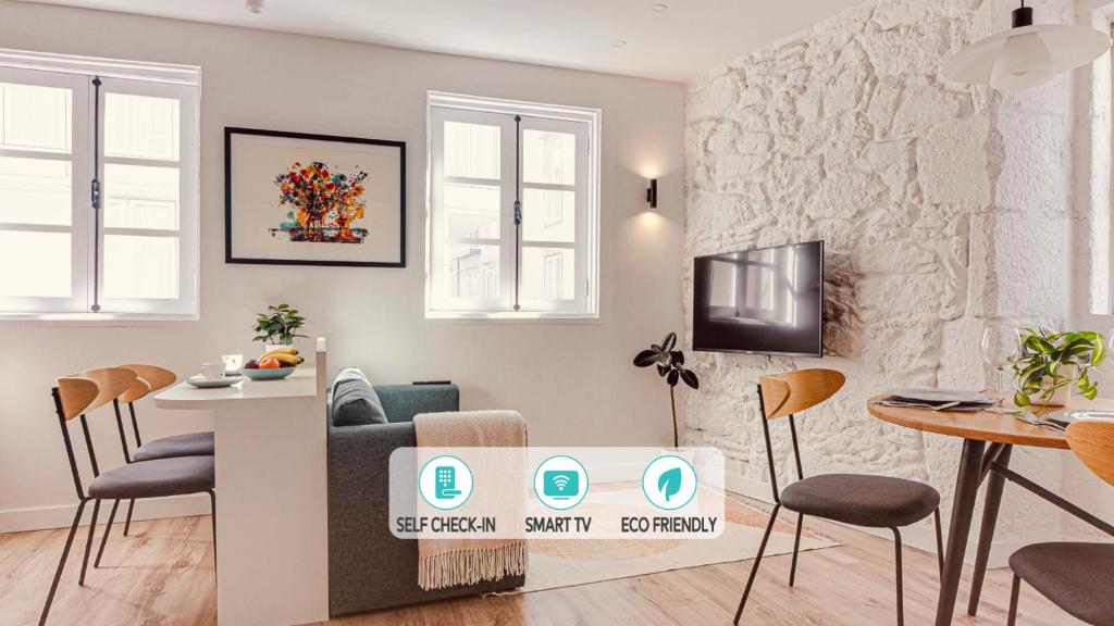 a living room with a couch and a table and chairs at Old Quarter Boutique in A Coruña