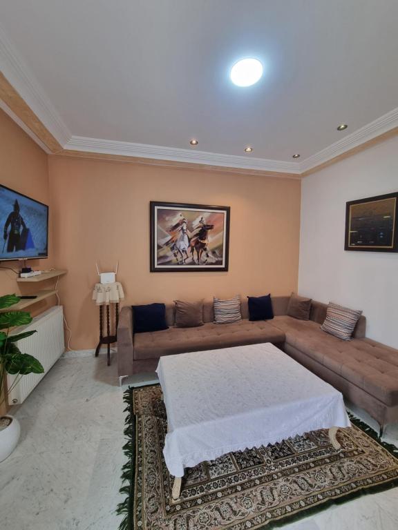 a living room with a bed and a couch at Perle studio lac 2 tunisia mall in Tunis